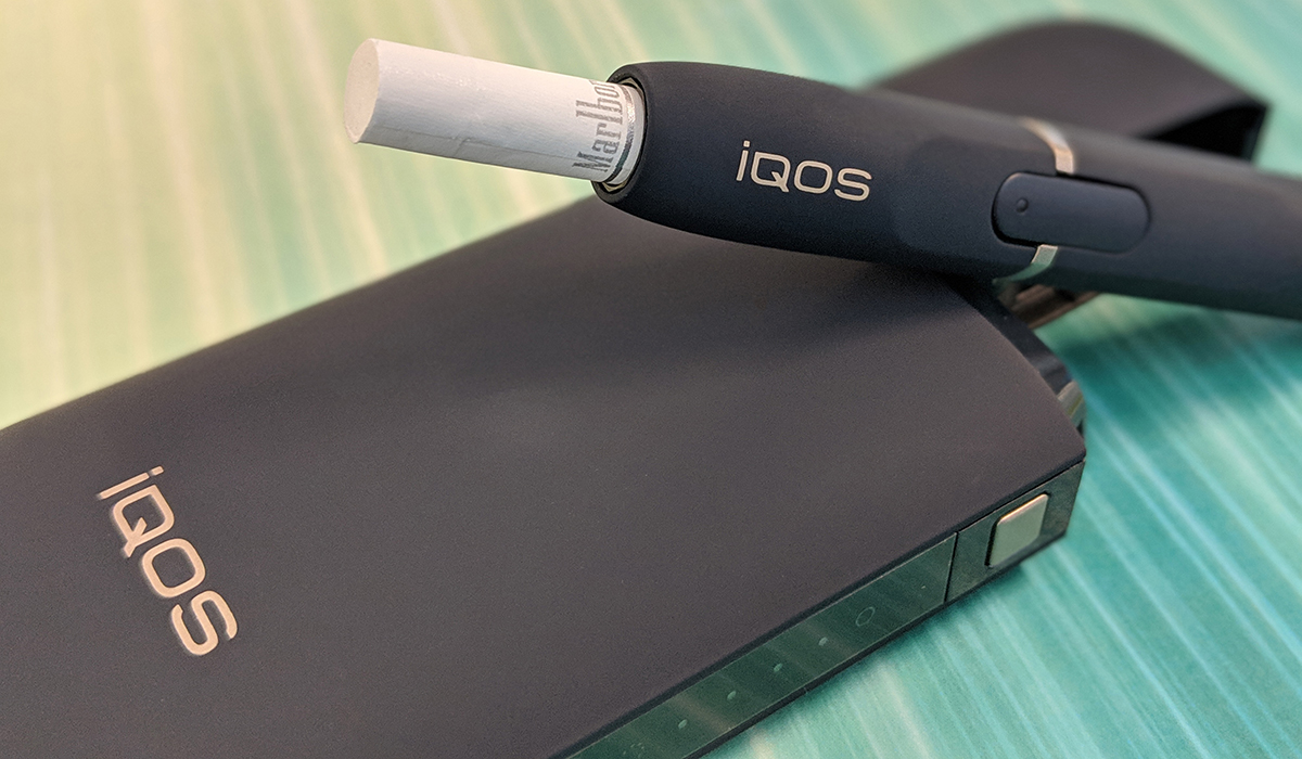 IQOS on a green background