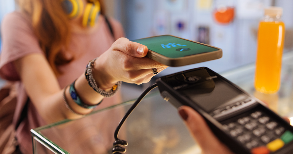 Young adult using tap to pay