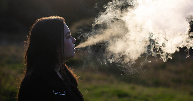 Girl vaping with big cloud