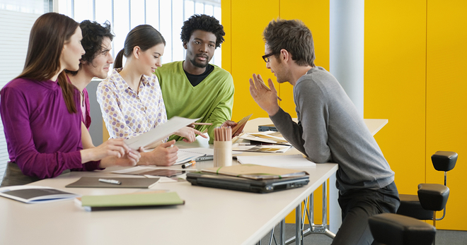 Workers in front of a yellow wall