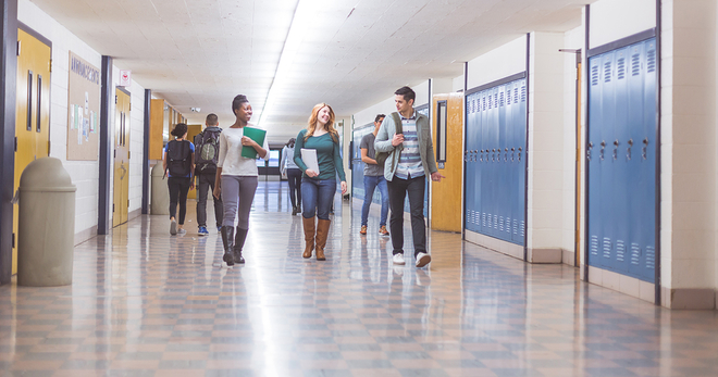 Students walking down a school hallway