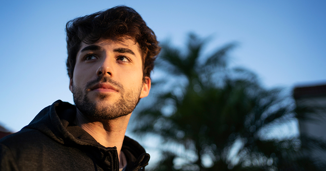 Man in front of a palm tree