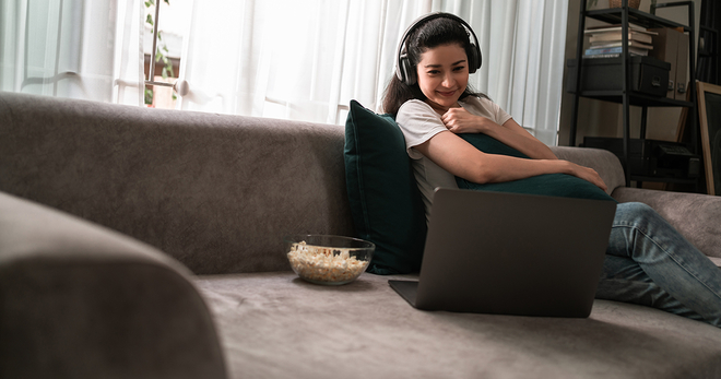 Streaming a movie on a laptop on the couch