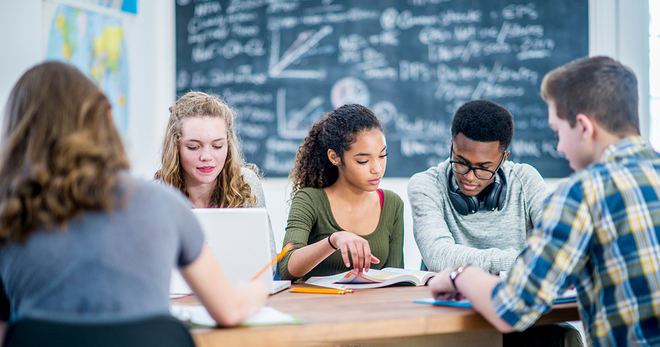 Students around a table studying