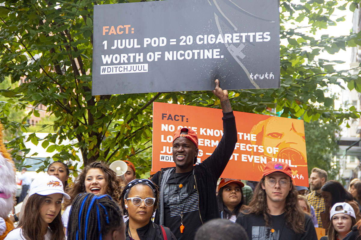 Sign holder at National Day of Action Rally